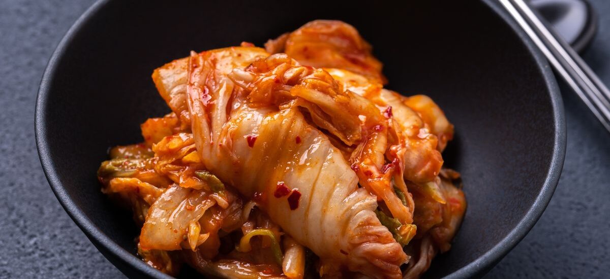 Freshly fermented Korean kimchi served in a black bowl, showcasing authentic flavors found at the Best Korean Restaurants.